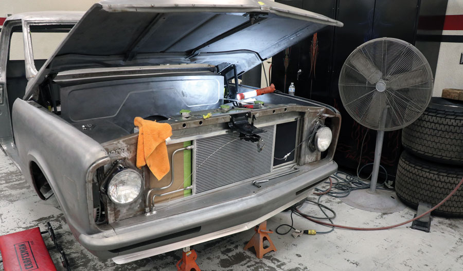 You can see how the front sheetmetal/bumper are blended to a tight fit, notice small air damn at bottom, and the custom mount for the radiator and Vintage Air condenser.