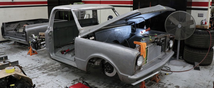 You can begin to see the body mods; chop, one-piece hood, tucked bumper, door now absorbs the rocker panel section and the fender opening were reworked.
