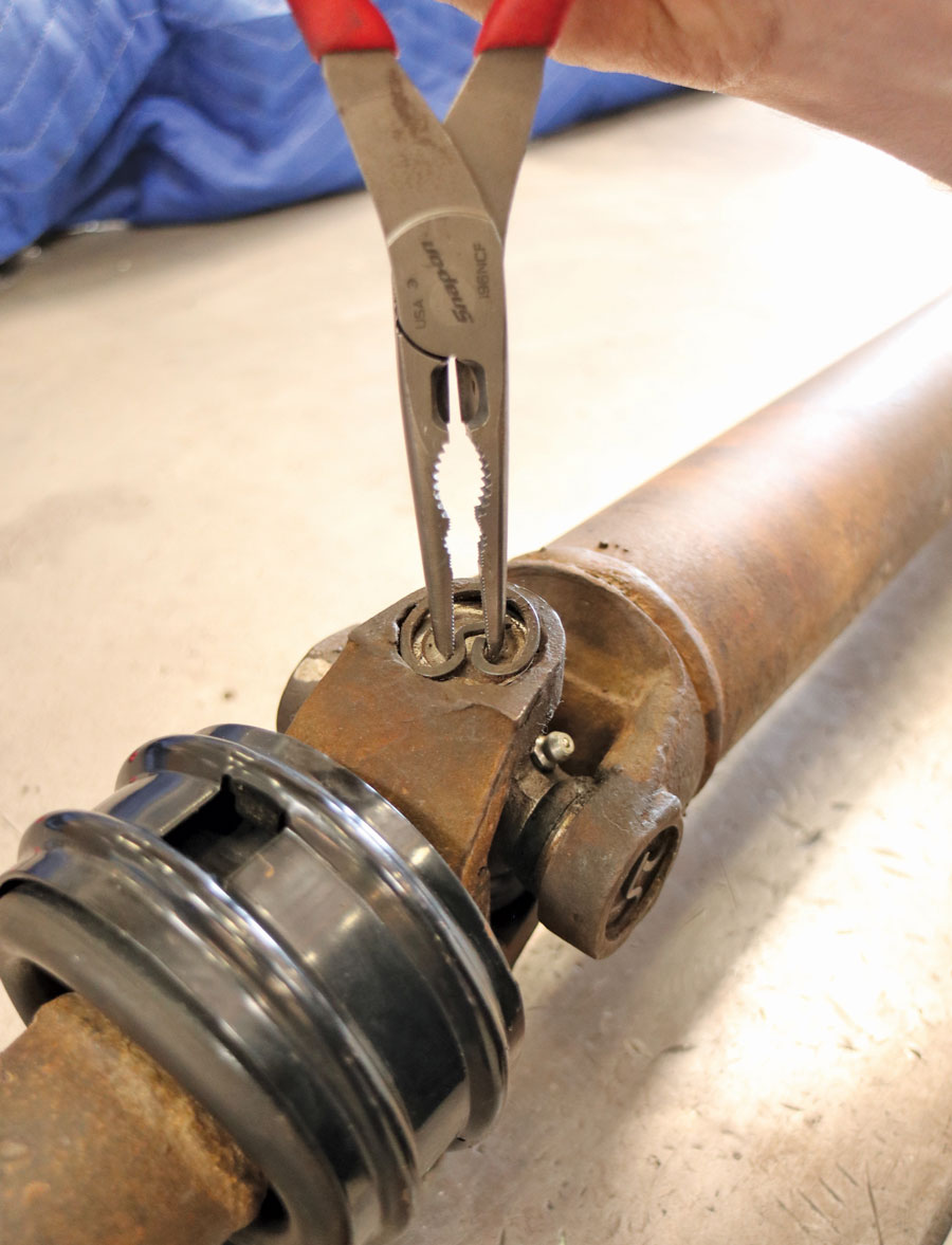5: If necessary, changing the center universal joint is achieved by removing the four snaprings and disassembling the universal joint assembly in order to remove it from the two yoke