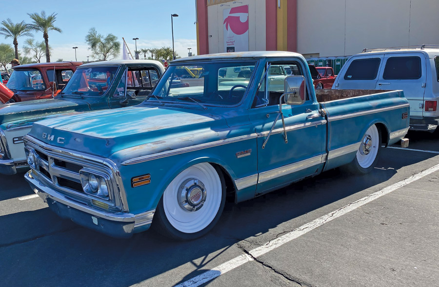 blue truck using white tires at a car show