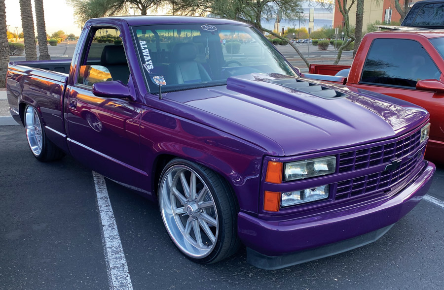 purple truck at a car show