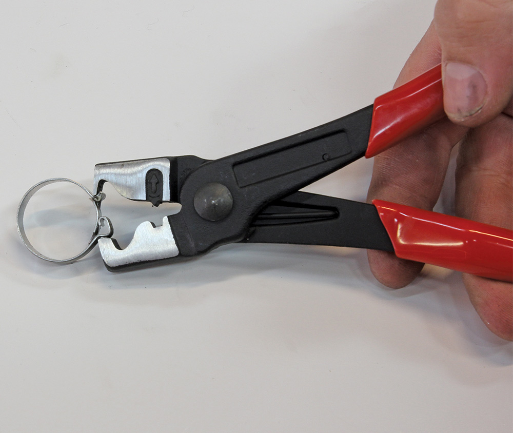 showing how the pliers should be positioned squarely on the clip connection points