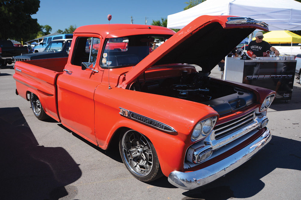 Tomato red Chevy truck with hood open