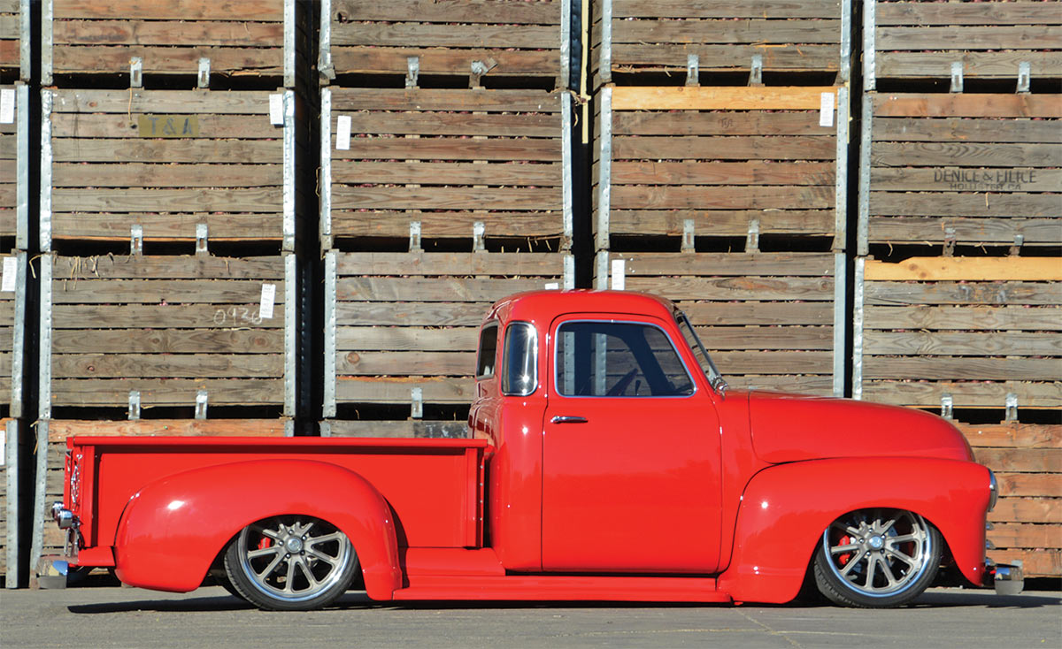 1953 Chevy 3100 side profile with wooden plank backdrop