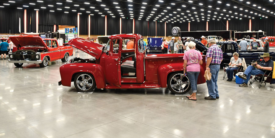 Red F-100 with people around it