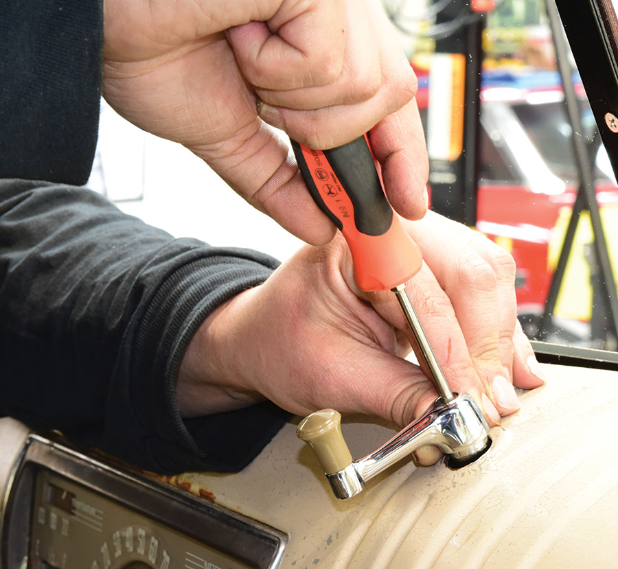 a fresh crank handle and knob installed using a flathead screwdriver