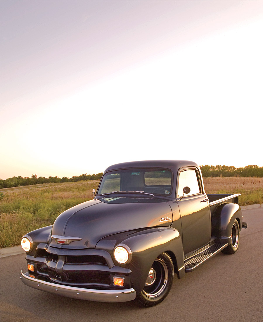 1954 Chevy 3100 on road with clear sky in background