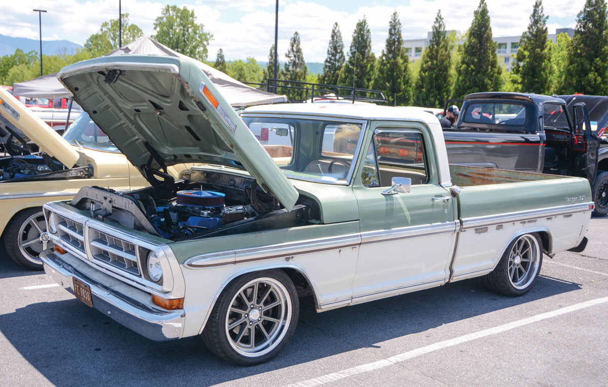 Green and white F-100 with the hood up