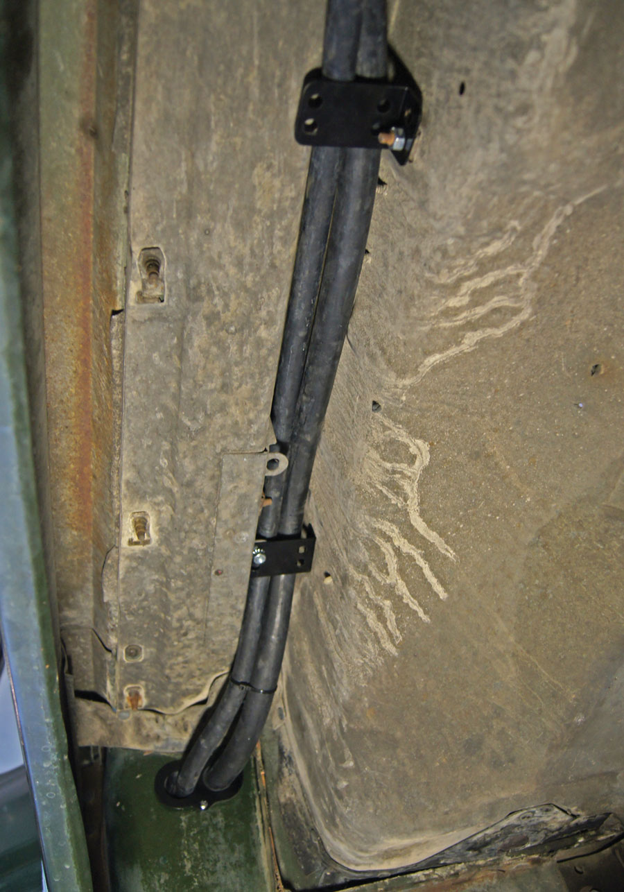 The number 10 hose has a bulkhead fitting that goes through the inner fender and then both lines are routed up to the top of the inner fender (above the tire) in a channel