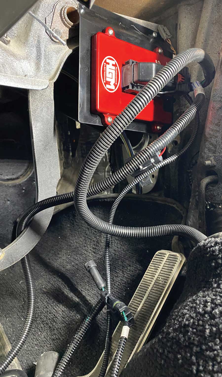 The bracket/TCU were attached to the right side of the brake pedal