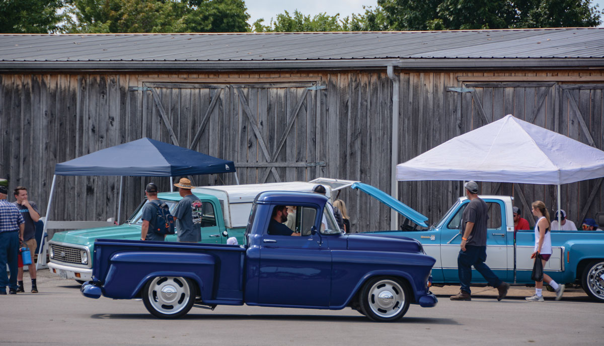 Three blue Chevy trucks