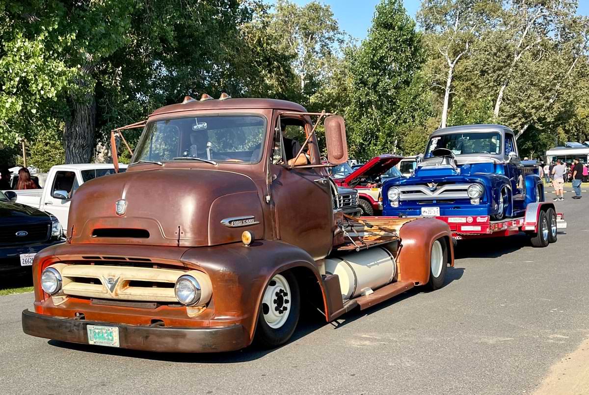 Brown F-100 pulling another truck behind it