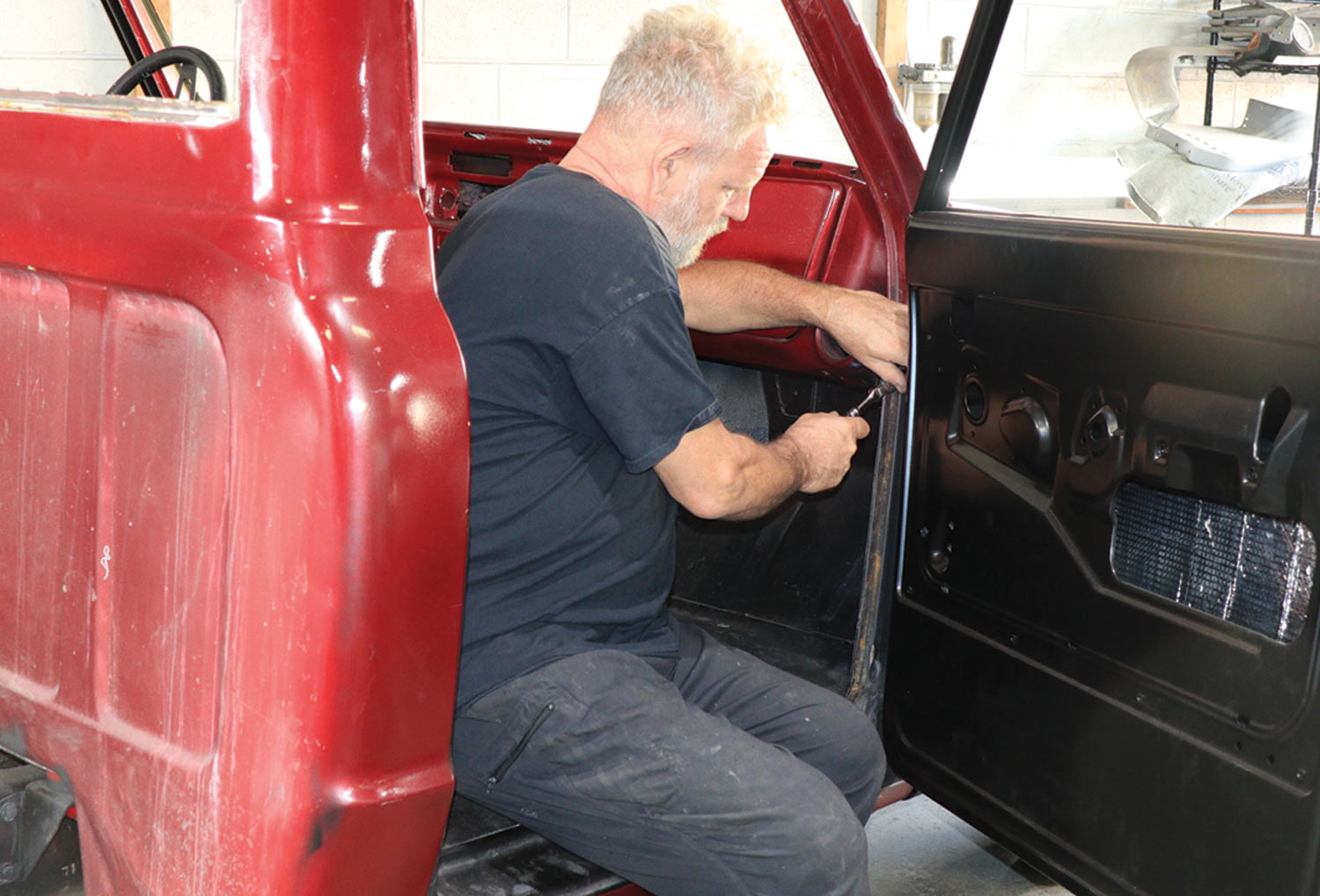 mechanic adjusts the gap from the fender to the door and gap between the door and the rear of the ’jamb