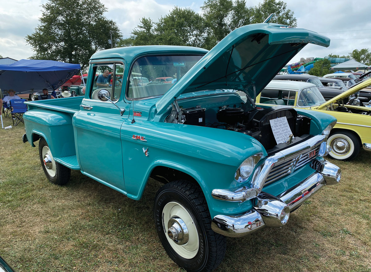 Teal truck with open hood