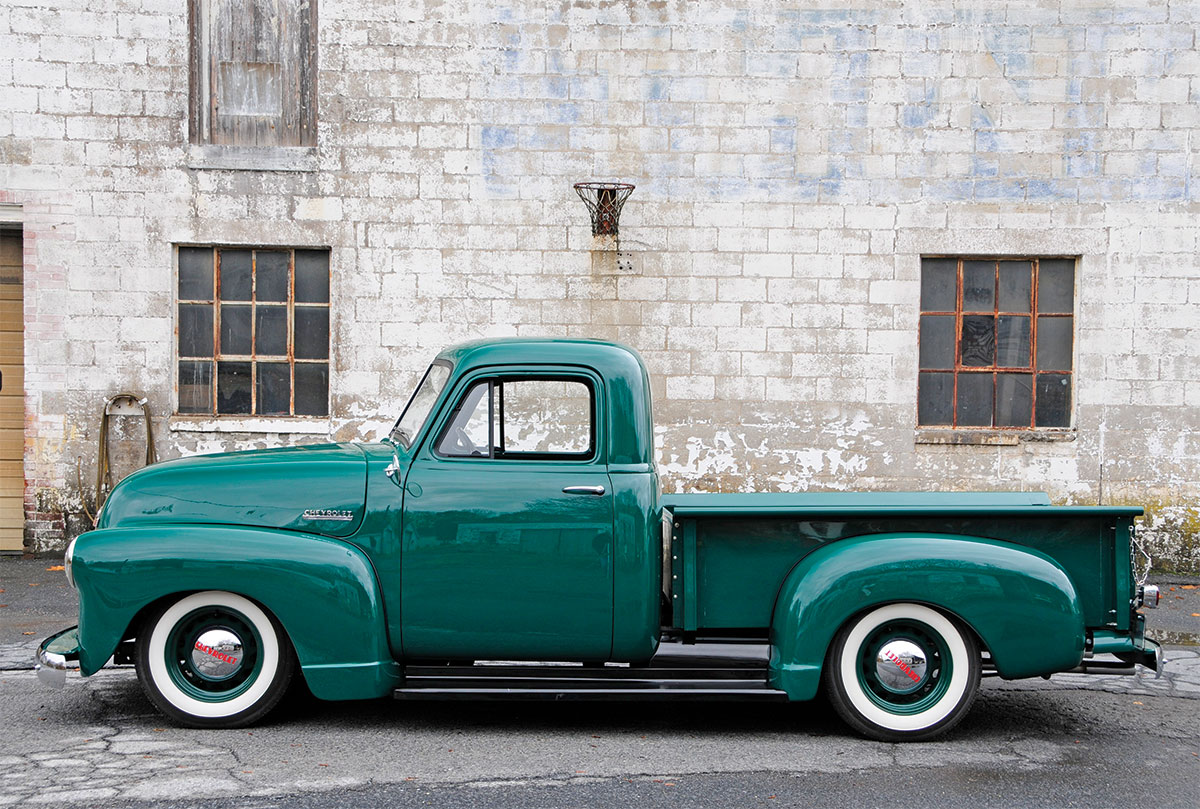 '52 Chevy side profile in front of brick building