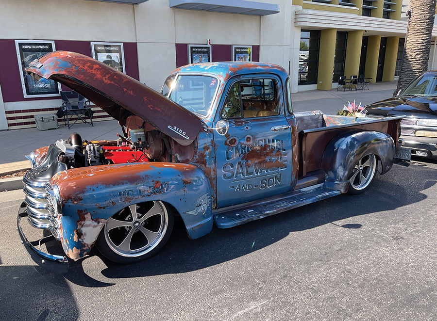 blue truck with brown rusted spots and hood open