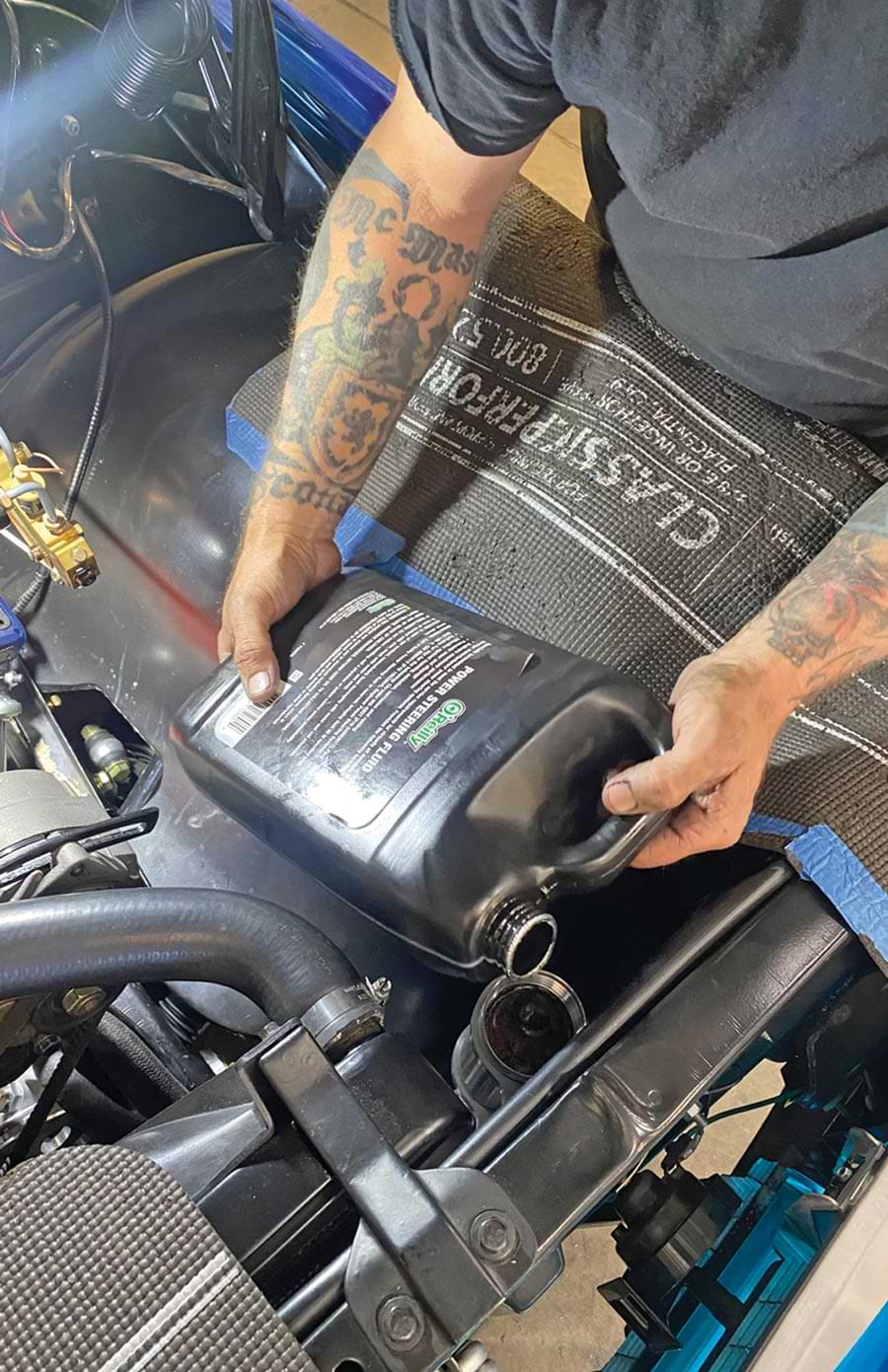 mechanic fills the system with fluid