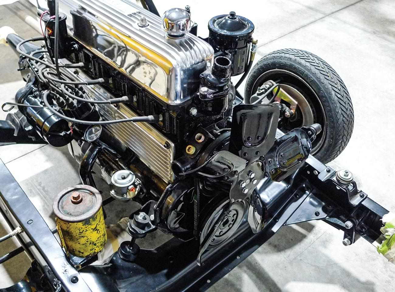 wider view of the yellow can installed on the car frame