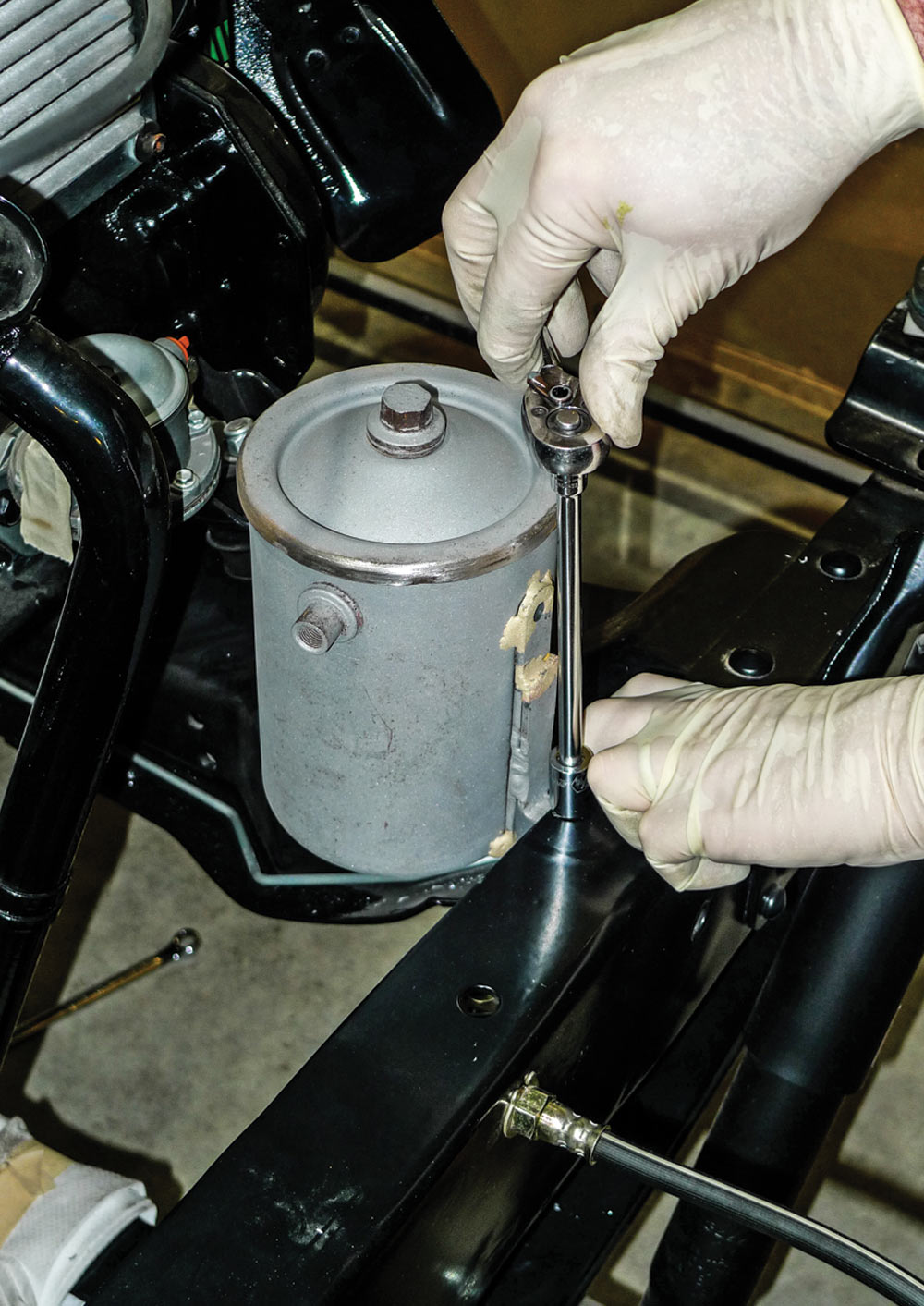 mechanic tightens the connection between the frame and can