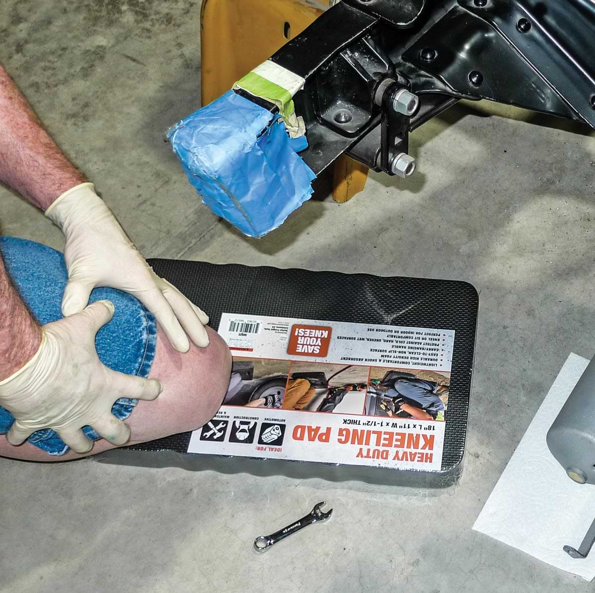 view of mechanic using a heavy duty knee pad