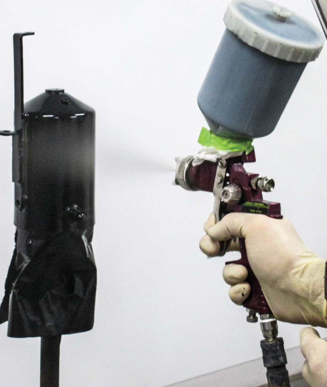 mechanic spray paints the recovery can black