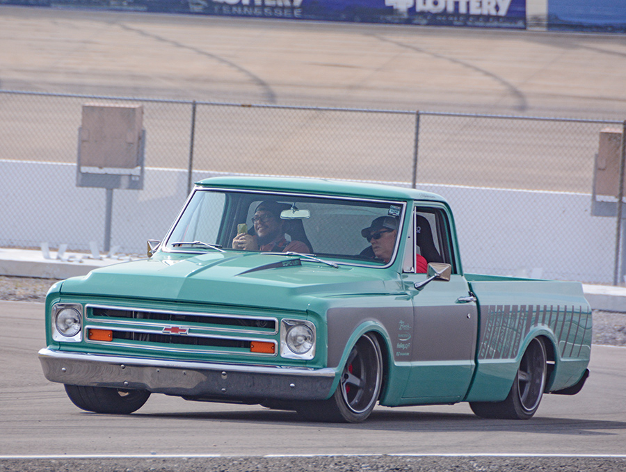 front view of teal chevy truck on the race track