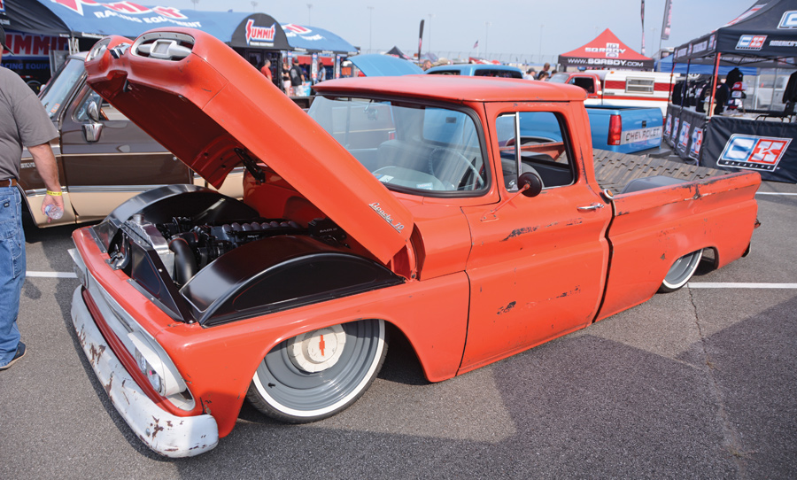 orange truck with lowered body and hood open