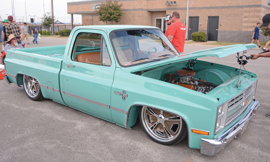 light blue truck with lowered body and hood open