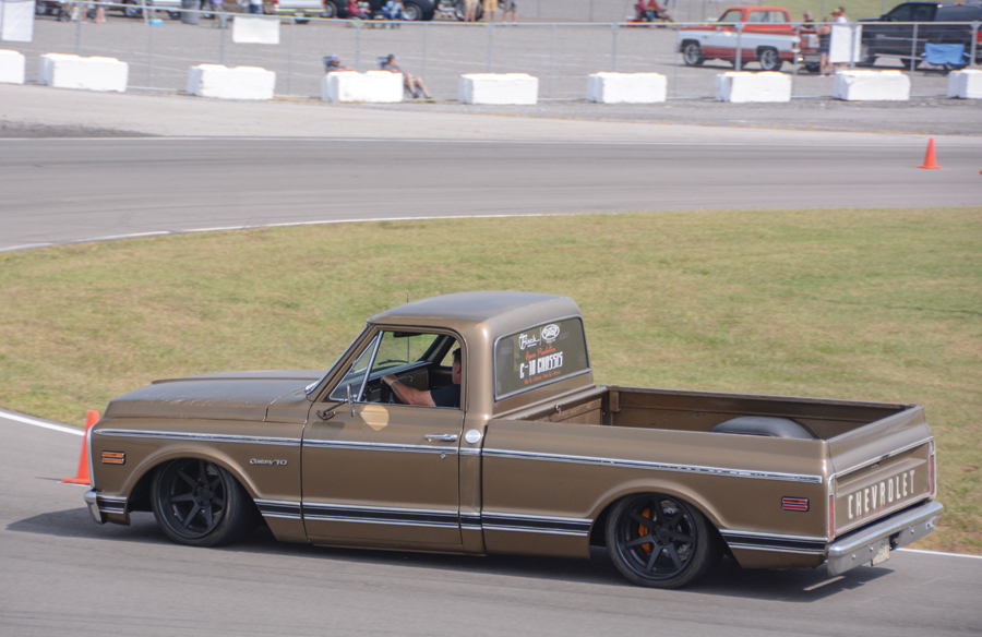 brown truck with lowered body on the race track