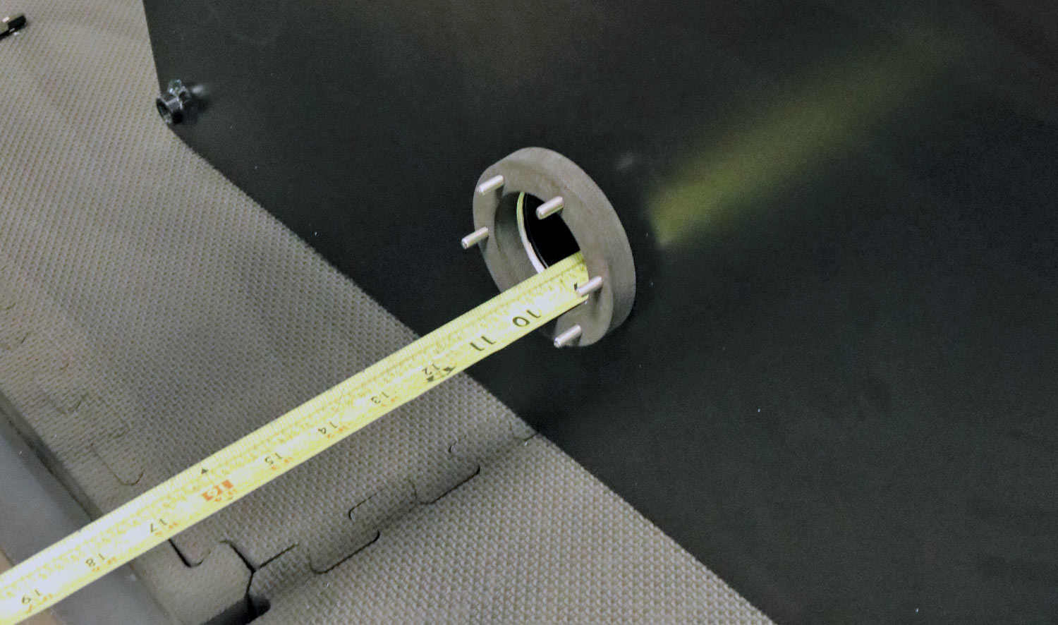 Measuring tape is used to determine the depth of the tank