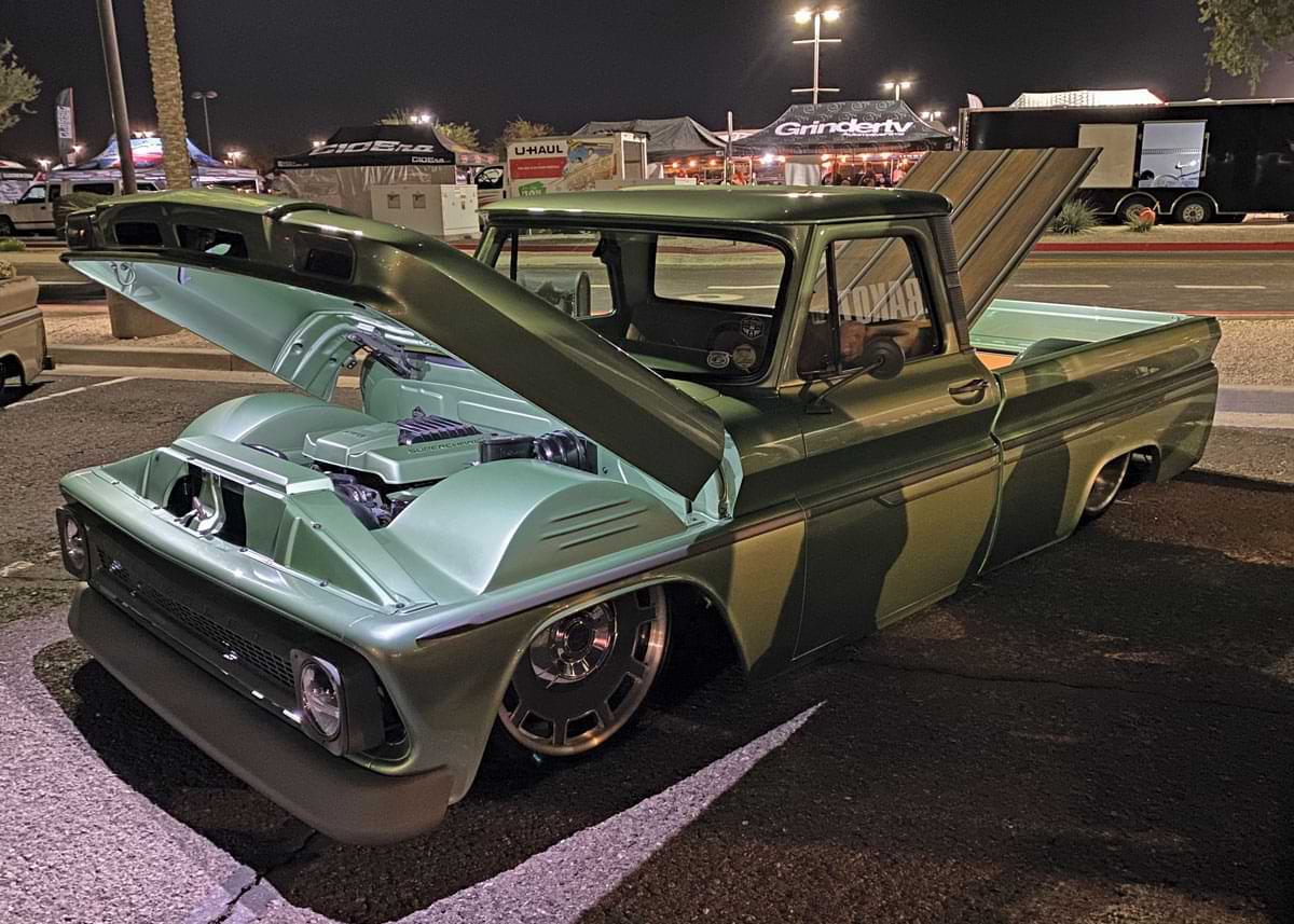 Green Chevy truck with raised hood