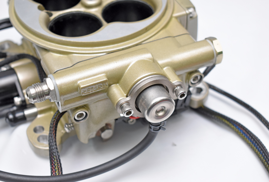 Mounted on the return side of the loop of the fuel delivery system is the pressure regulator. The fuel line fittings may be installed at the front rear of the throttle body.