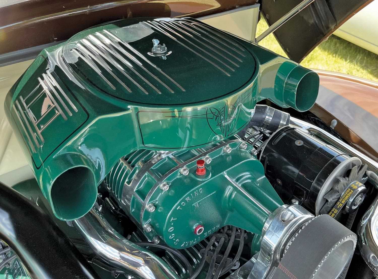 view of Powermaster's PowerGEN alternator installed on a green engine