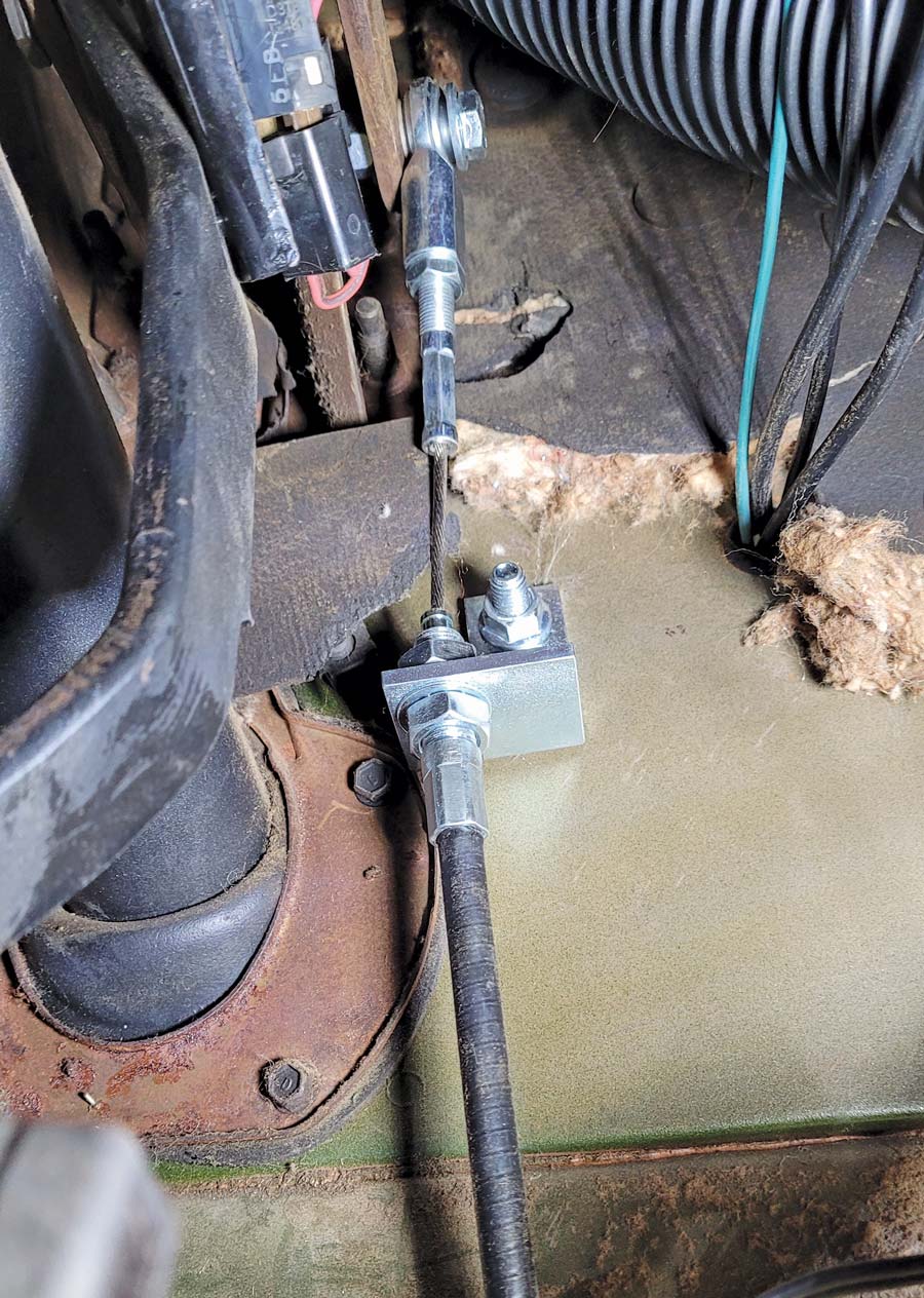 the cable mounts through the bracket and the heim joint end bolts to the pedal in the same hole the push rod was in from the factory