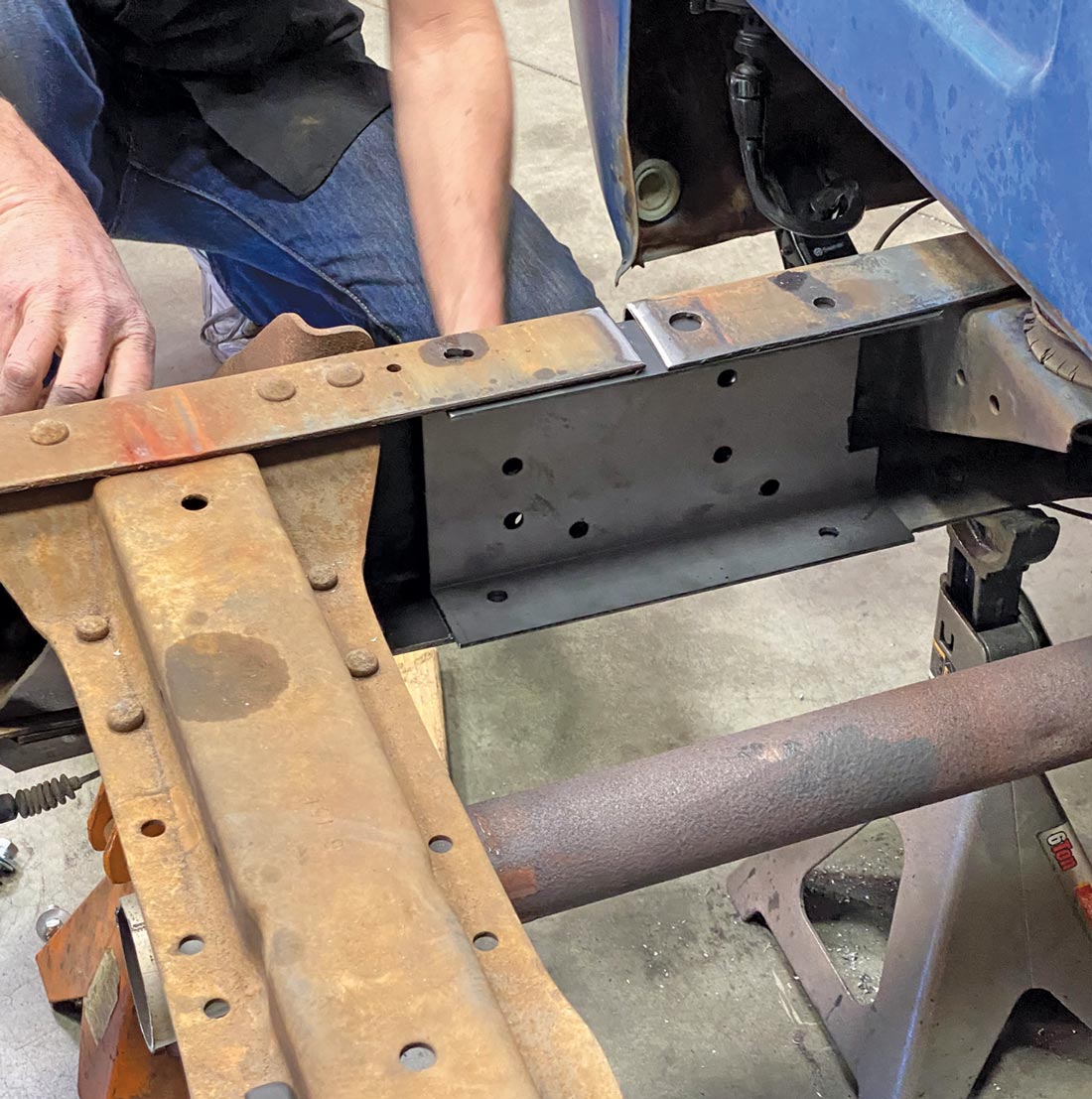 mechanic installs the C-channel into the front section of the frame