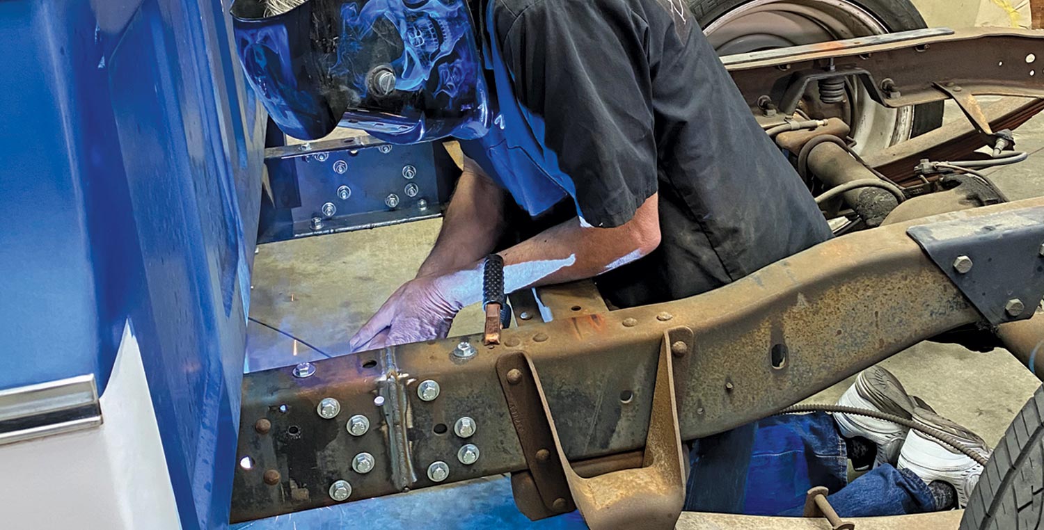 mechanic Dave welds the lower horizontal edge of the C-channel to the frame lip