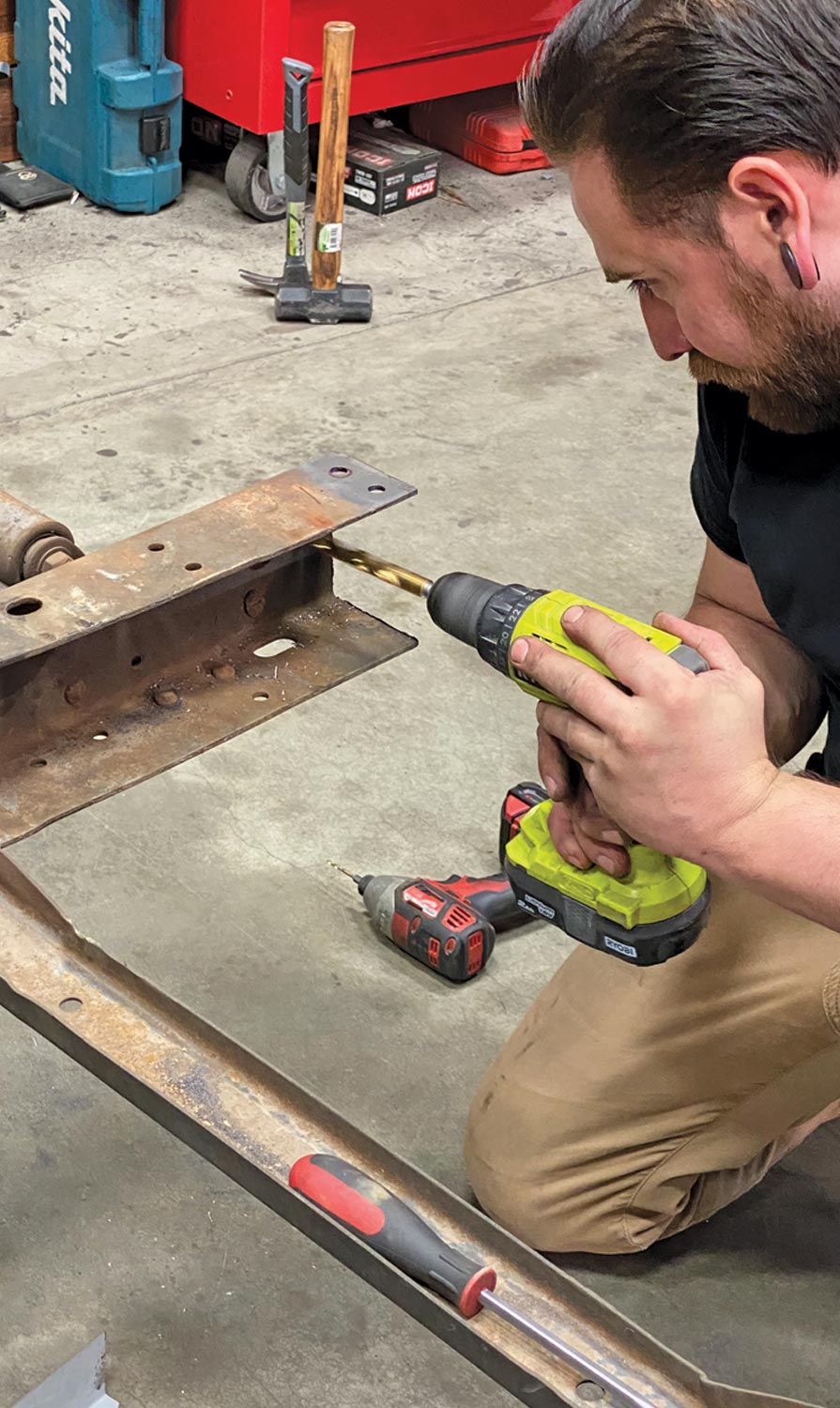 mechanic drills holes for the brackets