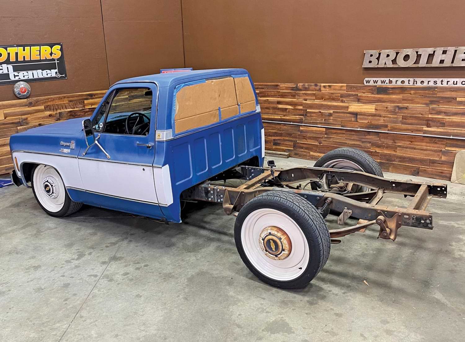 blue Chevy truck with bed removed and frame exposed