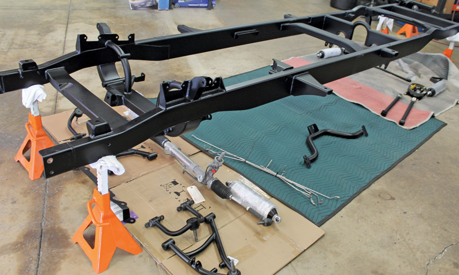  Freshly coated components are laid out for ease of locating. The assembly process will include the suspension, steering, brakes, and rear axle. The Wilwood disc brake kits will require assembly as well as the rear axle, which includes pressing the bearings onto the axles and mounting the Strange Engineering centersection. 