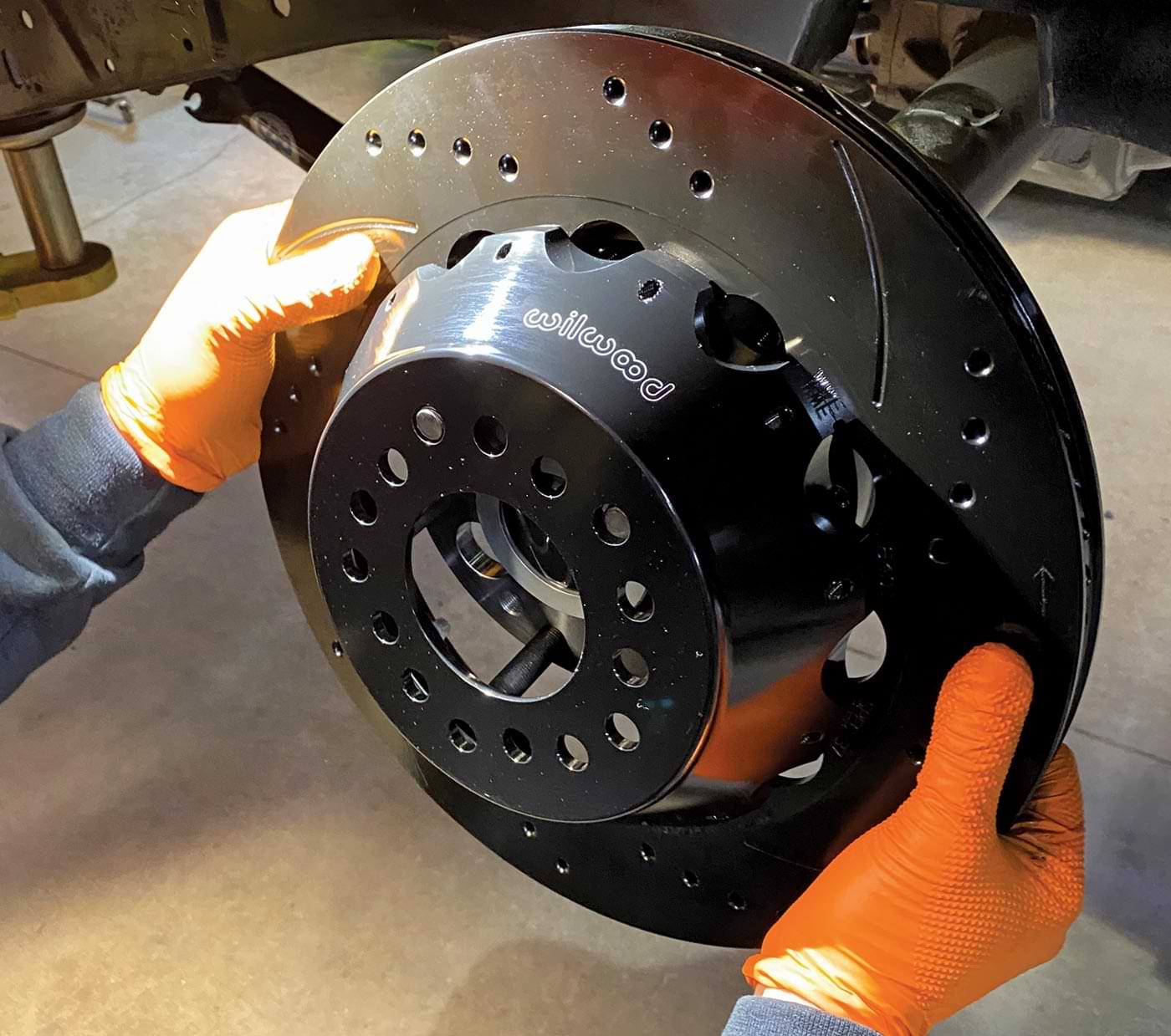 mechanic holds the freshly assembled 14-inch rotor in hand