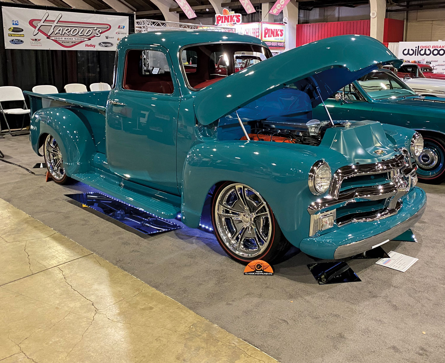 Blue truck with raised hood