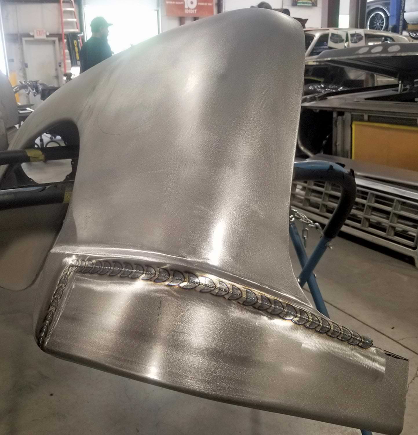 rear half of the driver side front fender in the middle of metalworking
