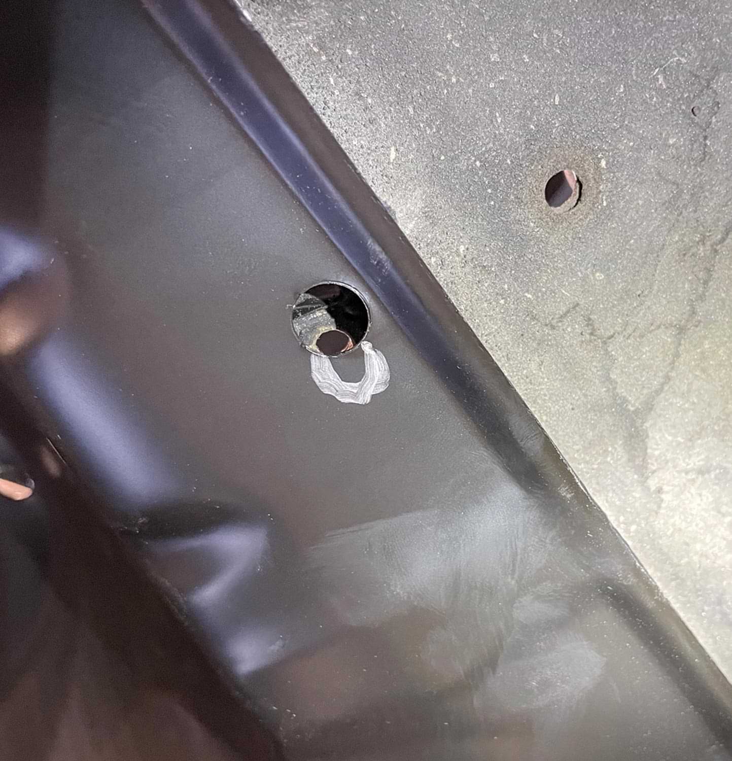 a hole in a part that doesn't match the hole mark