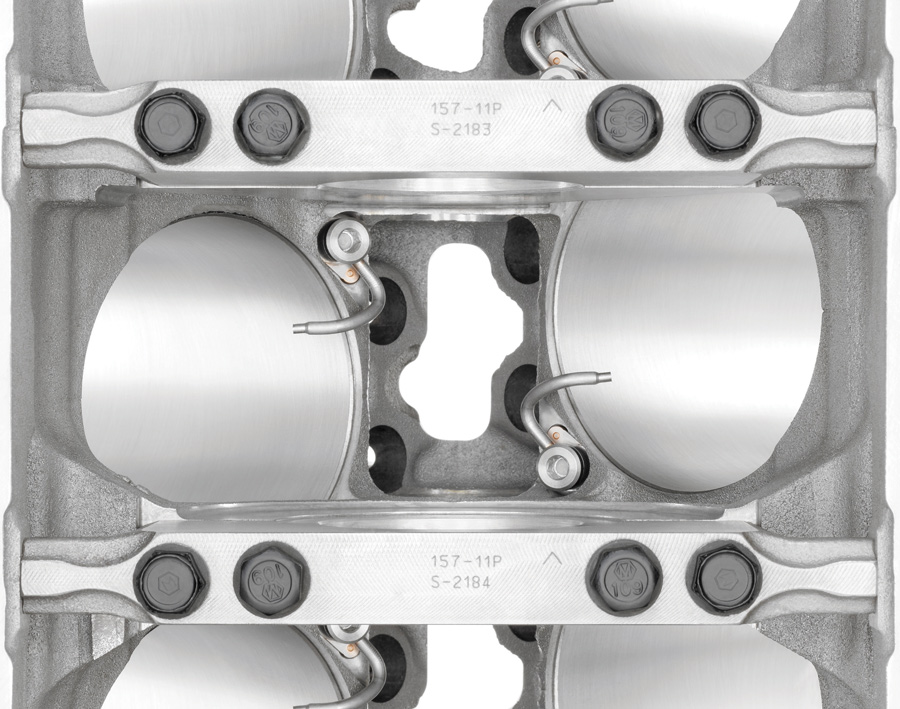Eight oil-spraying jets drench the underside of each piston and the surrounding cylinder wall