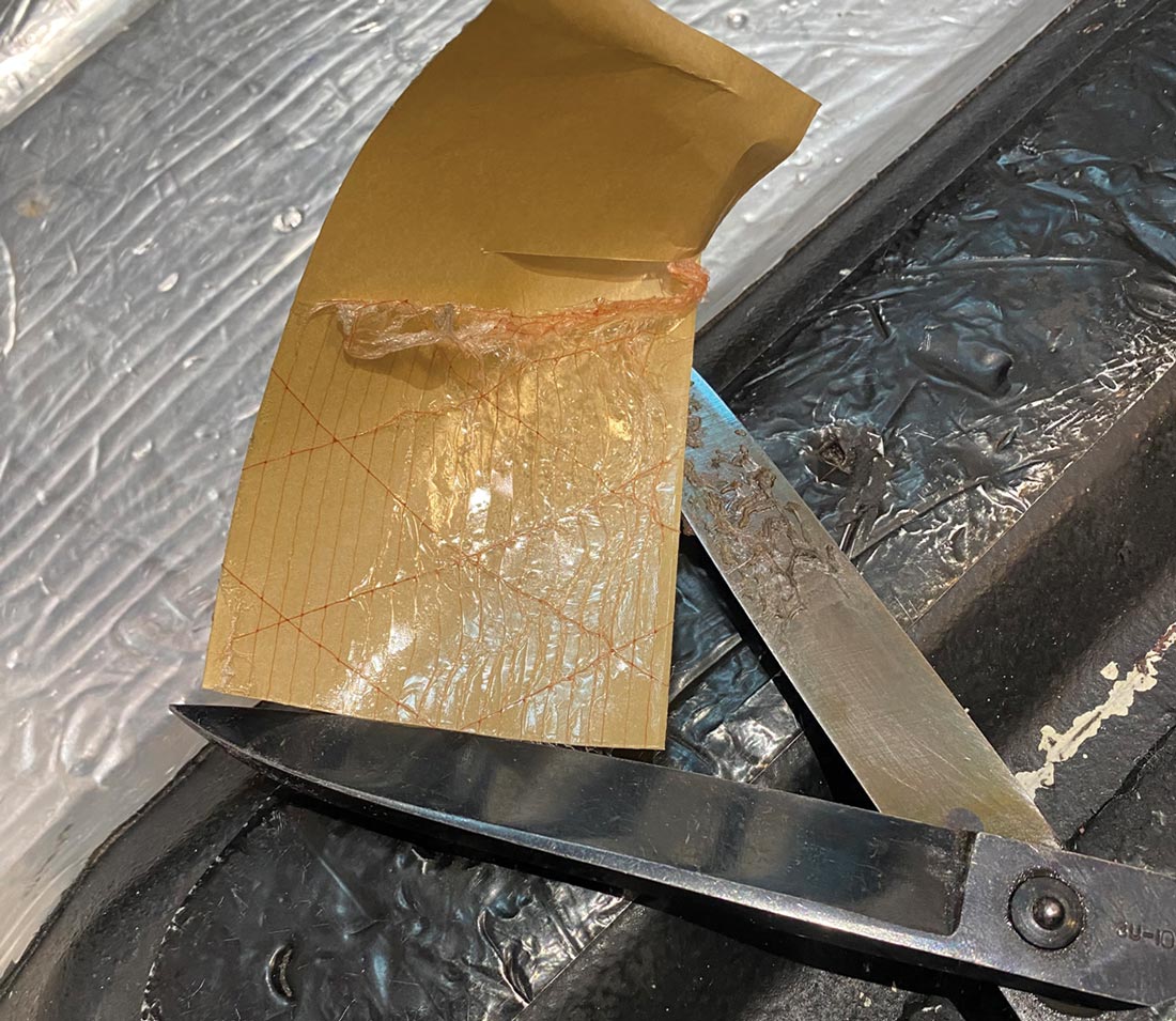 close view of an attempt to cut the adhesive transfer tape