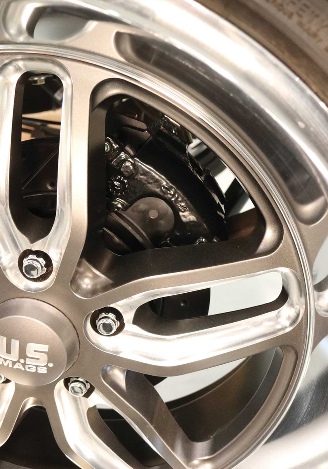 newly installed brakes covered with a 20-inch contrast-cut U.S. Mags rimmed tire