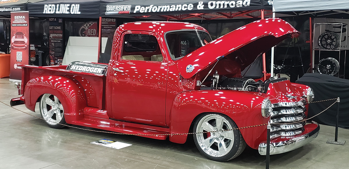 red truck with hood open