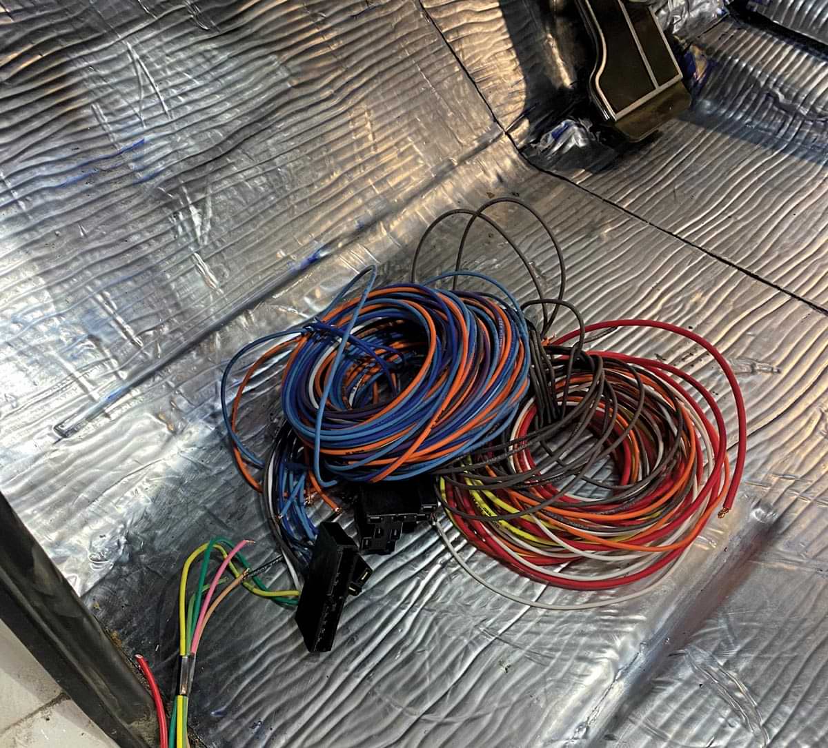 a pile of wires sit on the driver side floor