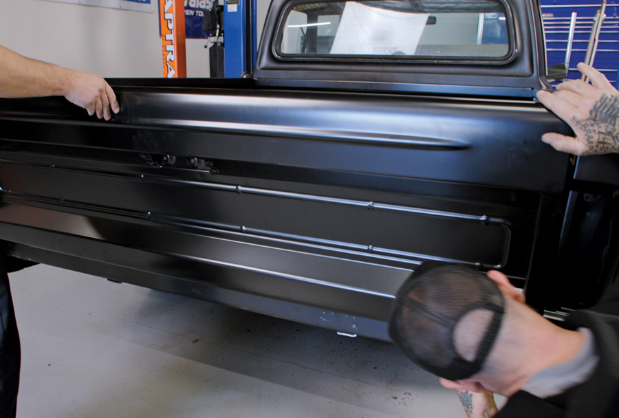 The tailgate is installed, along with the necessary latch mechanisms, release lever, and internal components. 