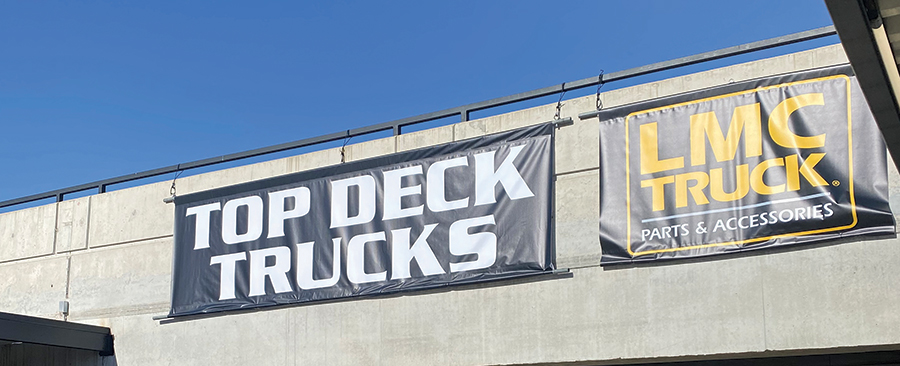 Top Deck Trucks banner outside garage